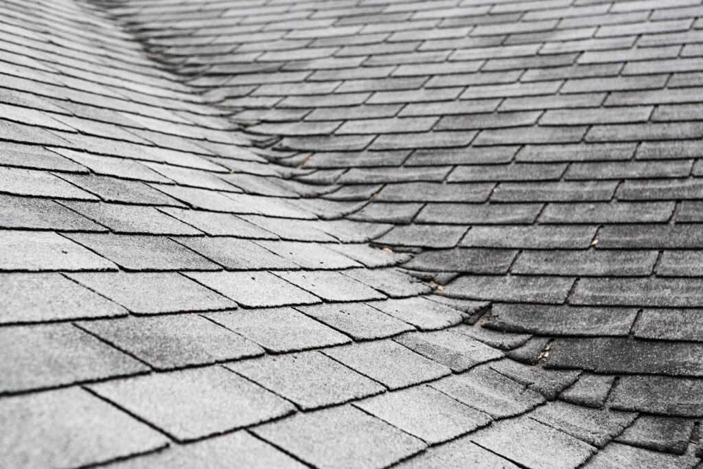 Old composite roofing in Dagsboro, DE, with damage