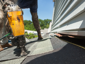 Professional Ocean View roofer securing shingles against storm damage