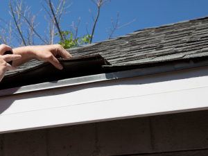 Close-up of a roof inspection in progress, showing the attention to detail by Roof Rite LLC.