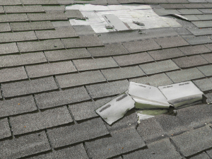 Wind damaged roofing shingles in Rehoboth Beach, CT.