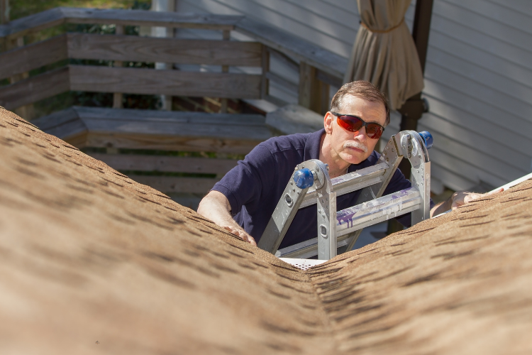 A professional roofer inspecting a roof in Rehoboth Beach, CT.