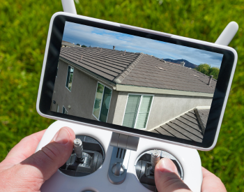 AA professional roofer conducting a roof inspection in Lewes with drone technology