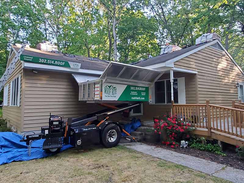 Roof Rite's Equipter parked next to a home undergoing a roof replacement