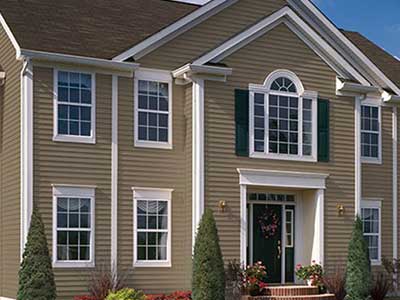 Large higher-end, two-story home with brown siding
