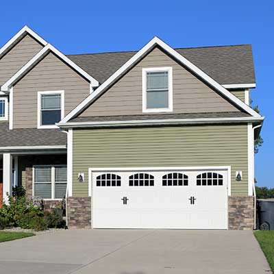 Mid-class, two-story home with light brown and green siding