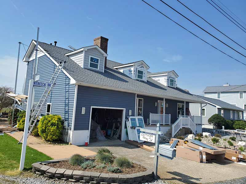 Large home getting new windows and siding installed by Roof Rite